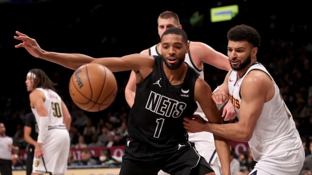Bridges chases a loose ball during the Nets' 122-117 loss to the Nuggets on Dec. 22, 2023.